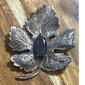 Vintage silver toned maple leaf pin with faceted Hematite stone